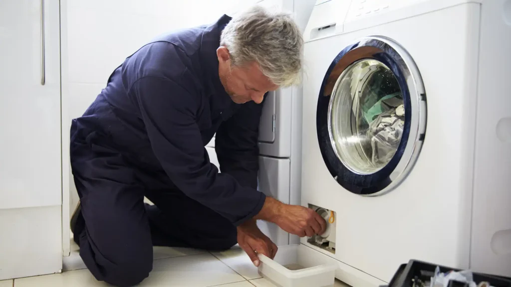 Samsung washing machine repair - Repairman fixing broken washing machine